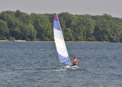 Dr. Phillips sailing in a boat on the St. Lawrence River